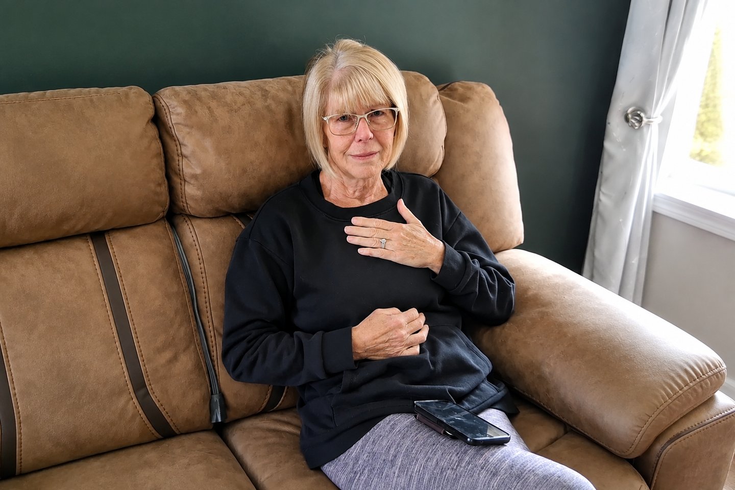A woman with her hand on her heart, moved by her song for a 70th birthday.