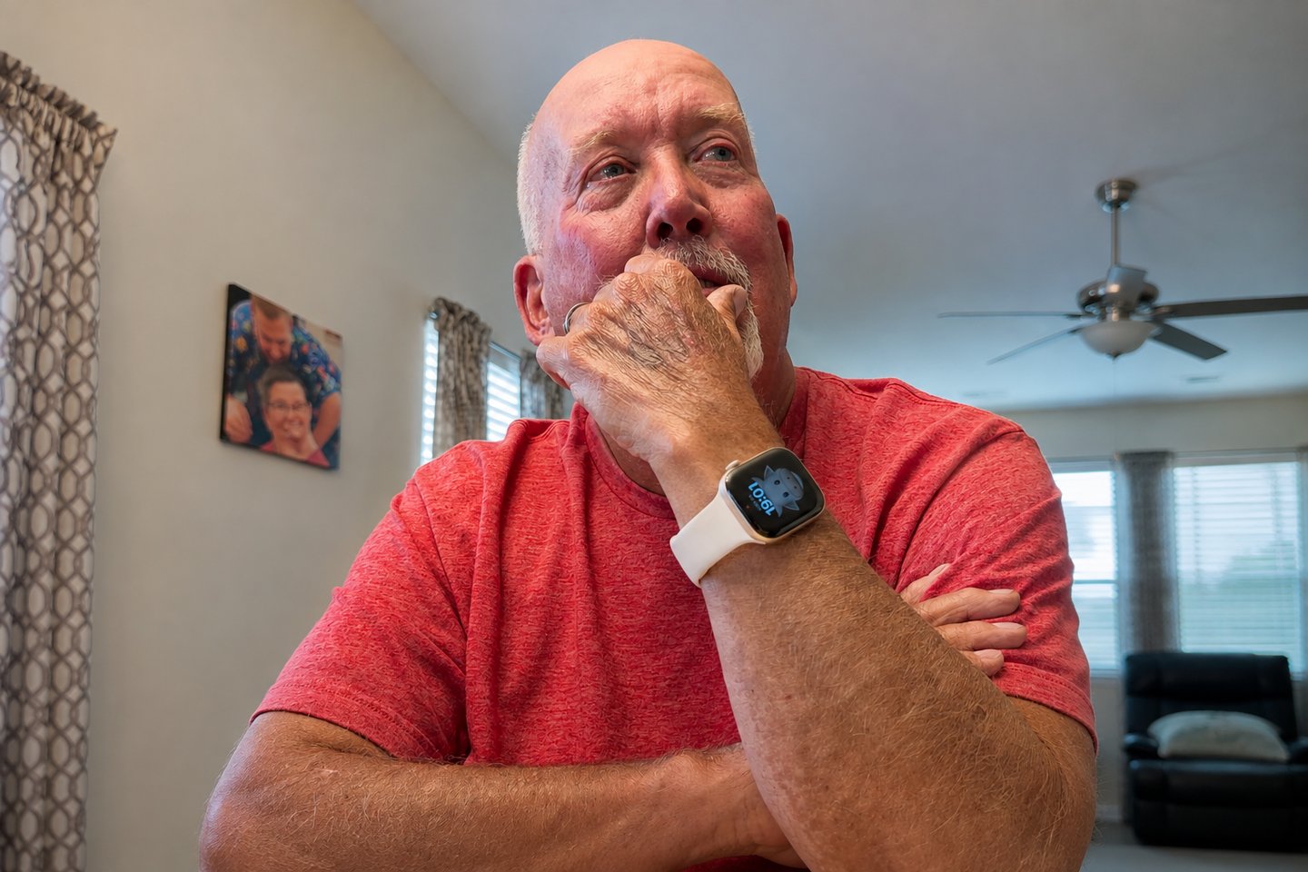 An older man reflecting quietly as he listens to a song for a military veteran.